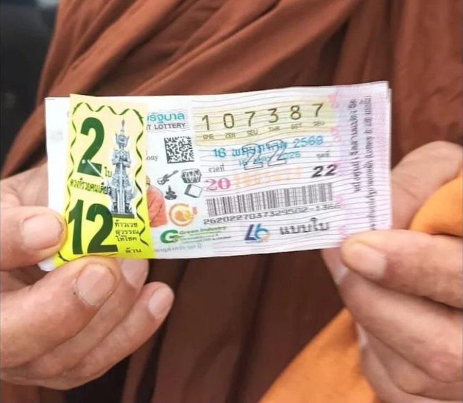 Close-up of the pair of Thai government lottery tickets numbered 107387 from the 16 May 2026 draw, with the vendor set label showing 2 tickets and 12 million baht