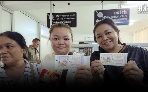 Thai lottery winners: two sisters from Buriram holding their first prize tickets numbered 287184 at Nang Rong police station