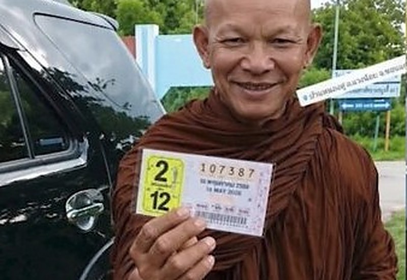 Thai lottery winner Phra Khru Amnuay, a monk in Khon Kaen, holding the winning ticket number 107387 from the 16 May 2026 government lottery draw